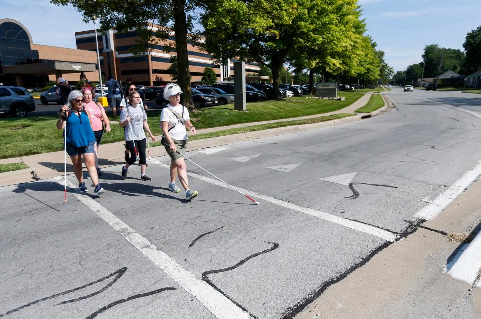 Instructor Reeda Rippee leads a group of students in a Missouri State University Orientation and Mobility Graduate Certificate program course on how to navigate traffic islands with visually impaired and blind students on Tuesday, June 27, 2023.