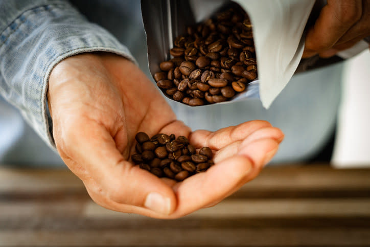 A person holding coffee beans
