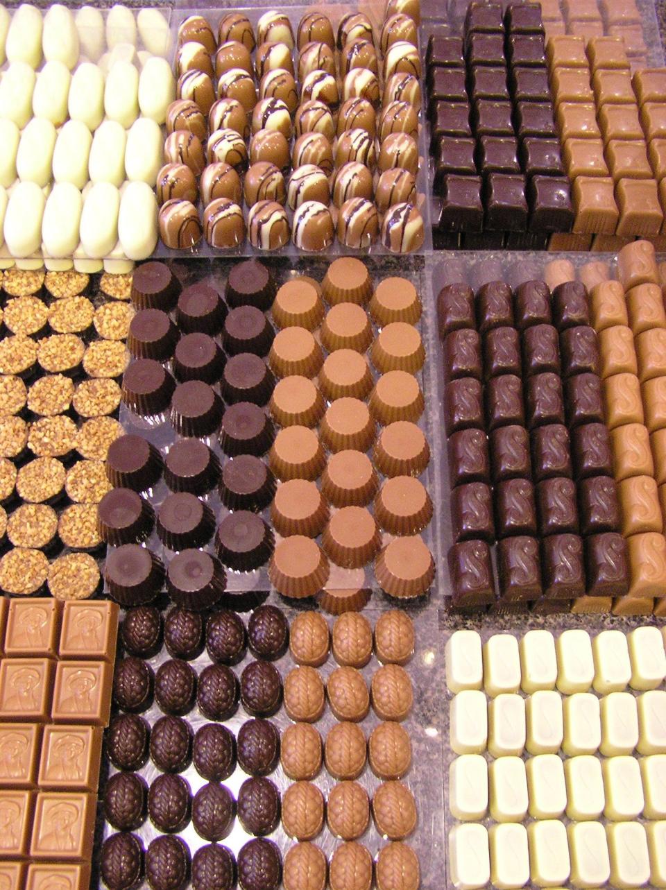 Chocolates line the case at Chocolaterie Stam on Ames' Main Street. The chocolate shop is giving away "Stam Bar" bundles of products in a collaboration with Stephens Auditorium ahead of Wednesday's production of the musical "Charlie and the Chocolate Factory."