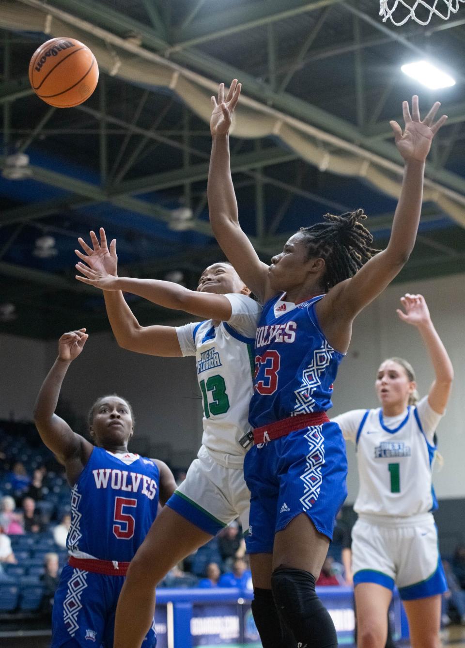 Jaden Langford (13) and Peace Okeke (23) fight for a rebound during the University of West Georgia vs University of West Florida women's basketball game at the University of West Florida in Pensacola on Wednesday, Jan. 25, 2023.