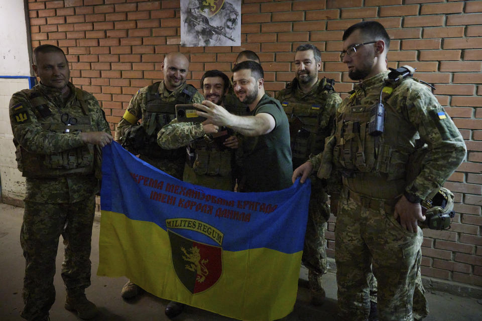 FILE - In this photo provided by the Ukrainian Presidential Press Office, President Volodymyr Zelenskyy, center right, takes a selfie with servicemen close to the front line in the Donetsk region of Ukraine, on June 5, 2022. Zelenskyy has ruled out any talks with Russia until it withdraws all of its forces from Ukrainian territory, including Crimea. (Ukrainian Presidential Press Office via AP, File)