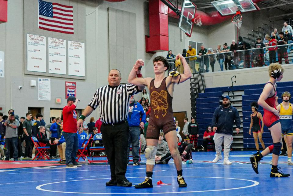Jacob Harris from Holt celebrates his 126 weight class match win at the CAAC Wrestling Championships Saturday, Feb. 3, 2024.