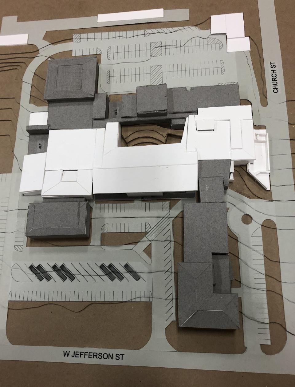 An architectural model of the proposed new Utica Middle School shows where the building and other new facilities will be (in gray) on the current campus, and the current building that will be demolished (in white).