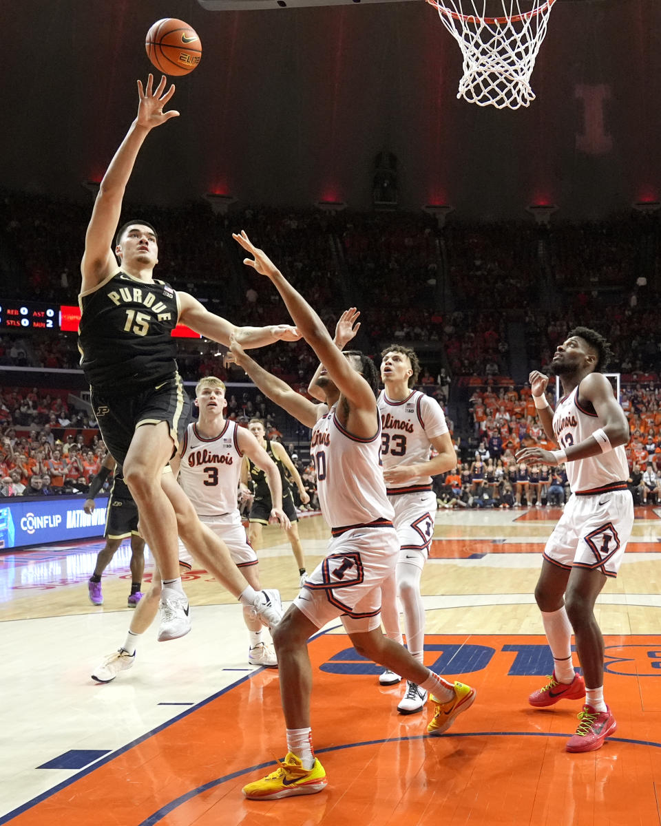 Zach Edey (15) shoots over Illinois' Ty Rodgers during the first half of an NCAA college basketball game Tuesday, March 5, 2024, in Champaign, Ill. (AP Photo/Charles Rex Arbogast)