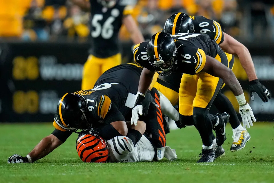 Cincinnati Bengals quarterback Jake Browning (6) is sacked by Pittsburgh Steelers defensive tackle Cameron Heyward (97) in the fourth quarter of the NFL 16 game between the Pittsburgh Steelers and the Cincinnati Bengals at Acrisure Stadium in Pittsburgh on Saturday, Dec. 23, 2023. The Steelers won 34-11.