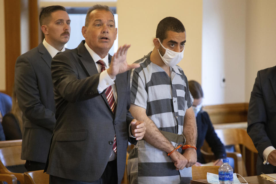 Hadi Matar, 24, right, listens as defense attorney Nathaniel Barone, left, speaks during an arraignment in the Chautauqua County Courthouse in Mayville, NY., Thursday, Aug. 18, 2022. Matar was arrested Aug. 12 after he rushed the stage at the Chautauqua Institution and stabbed Salman Rushdie in front of a horrified crowd. (AP Photo/Joshua Bessex)