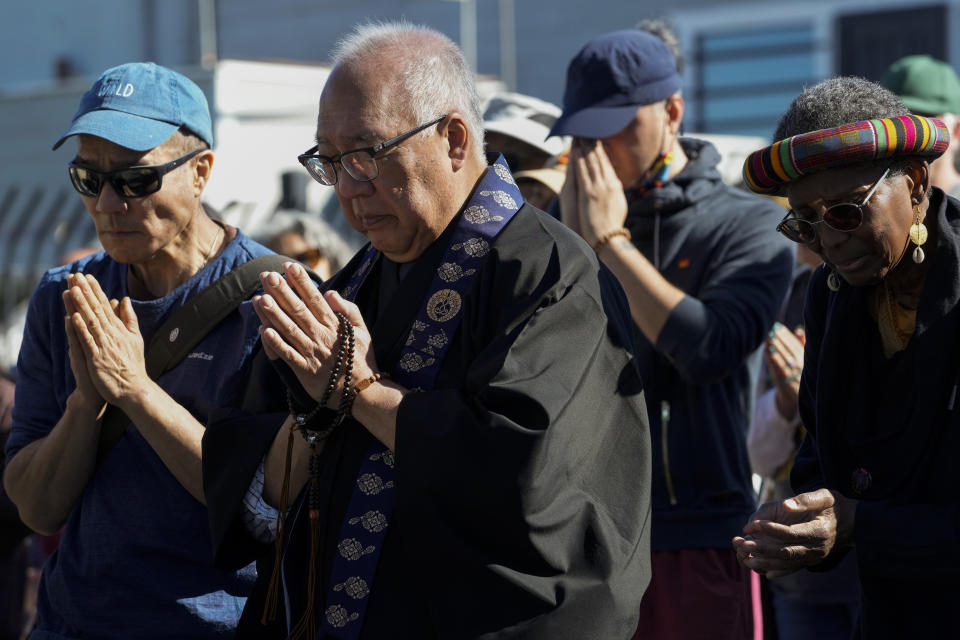 Buddhist faith leaders and community members pray during a "May We Gather" pilgrimage, Saturday, March 16, 2024, in Antioch, Calif. The event aimed to use karmic cleansing through chants, prayer and testimony to heal racial trauma caused by anti-Chinese discrimination in Antioch in the 1870s. (AP Photo/Godofredo A. Vasquez)