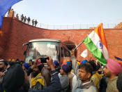 NEW DELHI, INDIA - JANUARY 26: Demonstrators at Red Fort during the farmers' tractor rally on Republic Day, on January 26, 2021 in New Delhi, India. Major scenes of chaos and mayhem at Delhi borders as groups of farmers allegedly broke barricades and police check posts and entered the national capital before permitted timings. Police used tear gas at Delhi's Mukarba Chowk to bring the groups under control. Clashes were also reported at ITO, Akshardham. Several rounds of talks between the government and protesting farmers have failed to resolve the impasse over the three farm laws. The kisan bodies, which have been protesting in the national capital for almost two months, demanding the repeal of three contentious farm laws have remained firm on their decision to hold a tractor rally on the occasion of Republic Day.(Photo by Sanjeev Verma/Hindustan Times via Getty Images)