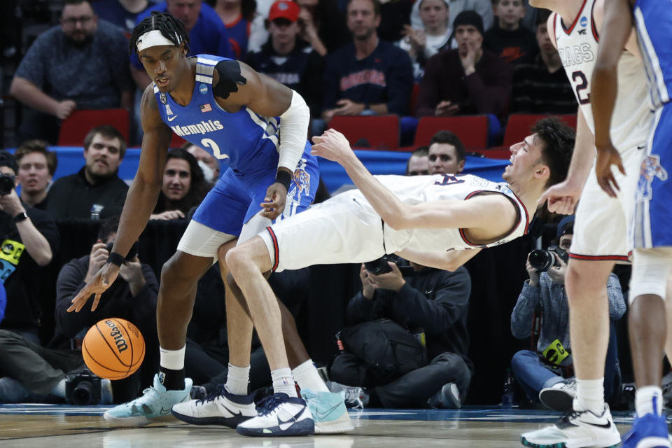 Memphis center Jalen Duren (2) dribbles the ball as Gonzaga center Chet Holmgren falls back during the second half of a second-round NCAA college basketball tournament game, Saturday, March 19, 2022, in Portland, Ore. (AP Photo/Craig Mitchelldyer)
