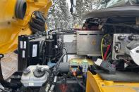 An engine compartment is visible for an electric school bus operating on Feb. 2, 2023, in Tok, Alaska. It works OK on the daily route, but because cold temperatures rob electric vehicle batteries of critical traveling range, No. 50 can't go on longer field trips, nor can it travel to Anchorage or Fairbanks if it needs repairs. It's the same problem that owners of electric passenger vehicles and transit officials are finding in cold climates worldwide. (AP Photo/Mark Thiessen)