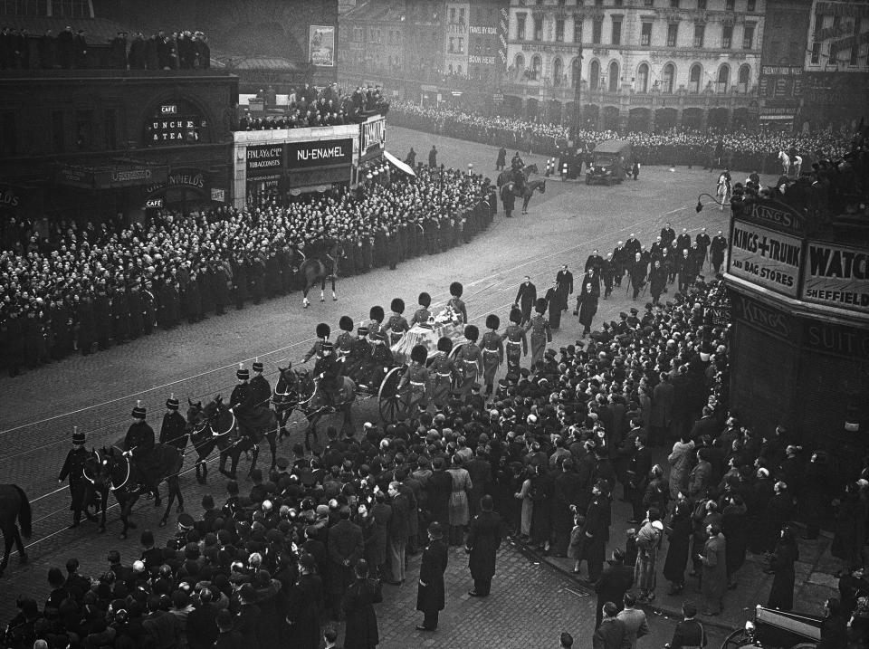 FILE - Vast crowds watched the coffin of the late King George V borne through London streets on a gun carriage to Westminster hall on Jan. 23, 1936, where the late Monarch will lie in state until the royal funeral. Hundreds of thousands of people are expected to flock to London’s medieval Westminster Hall from Wednesday, Sept. 14, 2022, to pay their respects to Queen Elizabeth II, whose coffin will lie in state for four days until her funeral on Monday. (AP Photo, File)