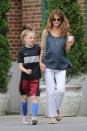 <p>Rusell wore white flared jeans with a gray tank while out with her son, River, in New York. (Photo: AKM-GSI) </p>