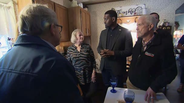 PHOTO: Ohio Gov. Mike DeWine, left, and EPA Administrator Michael Regan, second from right, talk with resident Carolyn Brown while visiting her home in East Palestine, Ohio, Feb, 21, 2023, following the Feb. 3 train derailment and chemical fire. (ABC News)