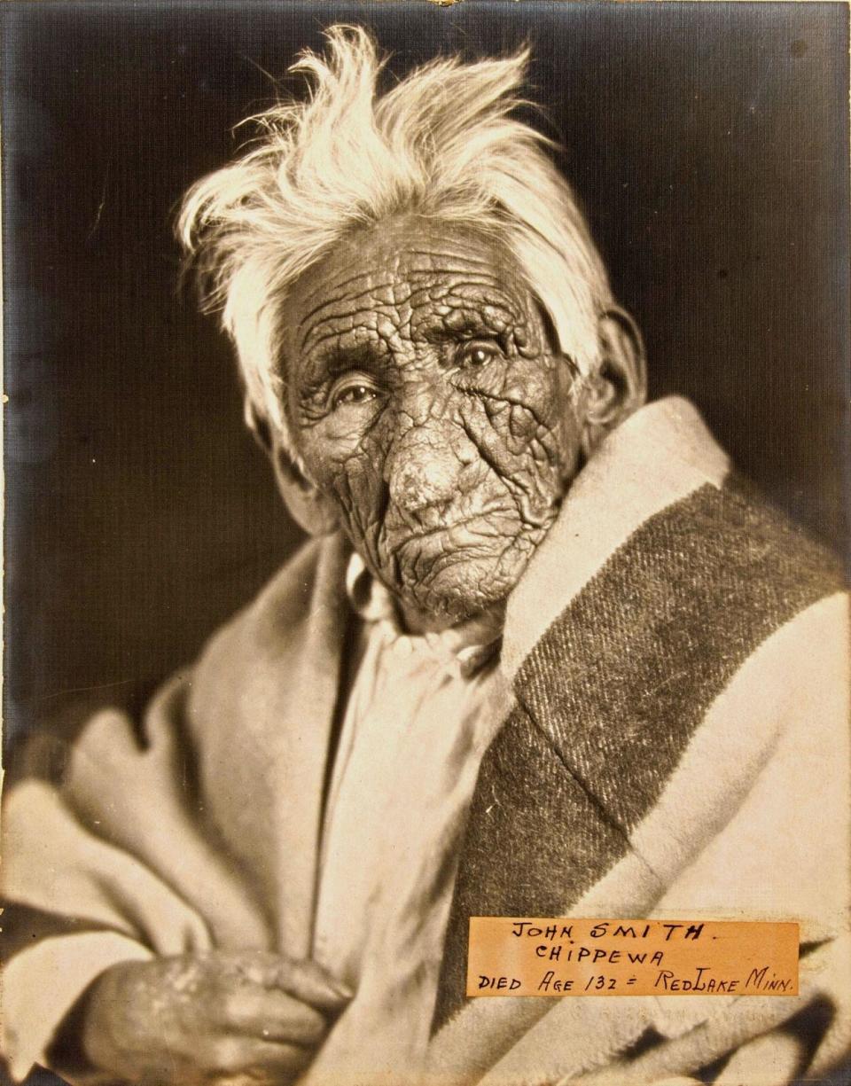 Close-up of a man with a full head of white hair and deeply creviced skin