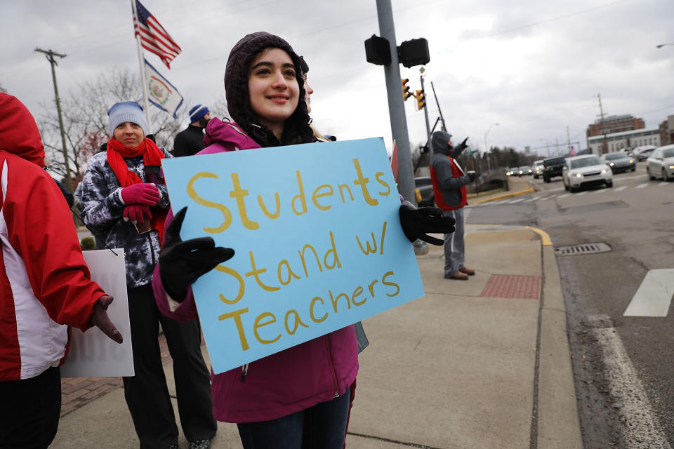 <p>West Virginia teachers, students and supporters hold signs on a Morgantown street as they continue their strike on March 2, 2018 in Morgantown, W.Va. (Photo: Spencer Platt/Getty Images) </p>