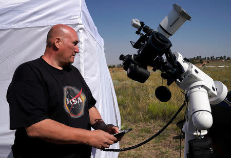 Rick Roty works with his telescope in a designated eclipse viewing area in a campground near Guernsey, Wyoming, U.S., August 20, 2017. REUTERS/Rick Wilking