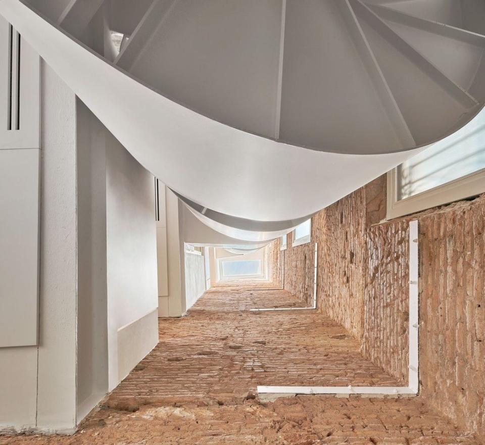 View down into the renovated BSP 20 apartment in Barcelona, with the home's central spiral staircase visible on top.