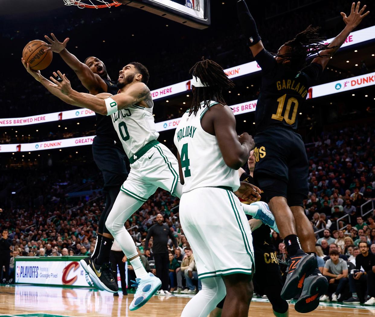 Cavaliers center Tristan Thompson (13) tries to stop Boston Celtics forward Jayson Tatum (0) from getting a shot up during the third quarter of Game 1.