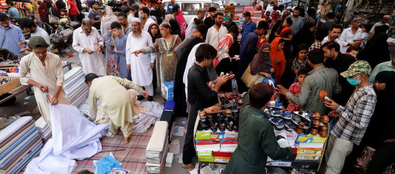 FILE PHOTO: File picture of people shopping from stalls ahead of the Eid al-Fitr celebrations