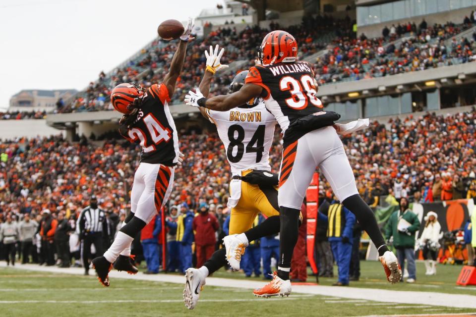 <p>Cincinnati Bengals cornerback Adam Jones (24) and strong safety Shawn Williams (36) break up a pass to Pittsburgh Steelers wide receiver Antonio Brown (84) in the second half of an NFL football game, Sunday, Dec. 18, 2016, in Cincinnati. (AP Photo/Frank Victores) </p>