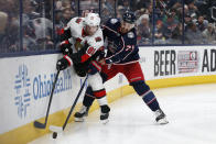 Ottawa Senators' Ron Hainsey, left, and Columbus Blue Jackets' Nick Foligno fight for the puck during the second period of an NHL hockey game Monday, Feb. 24, 2020, in Columbus, Ohio. (AP Photo/Jay LaPrete)