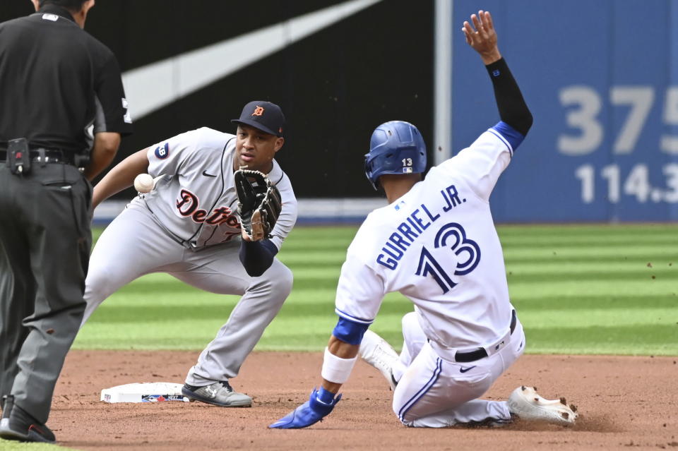 Lourdes Gurriel Jr., right, is put out at second base on an attempted steal by Detroit Tigers second baseman Jonathan Schoop in the first inning of a baseball game in Toronto, Saturday, July 30, 2022. (Jon Blacker/The Canadian Press via AP)