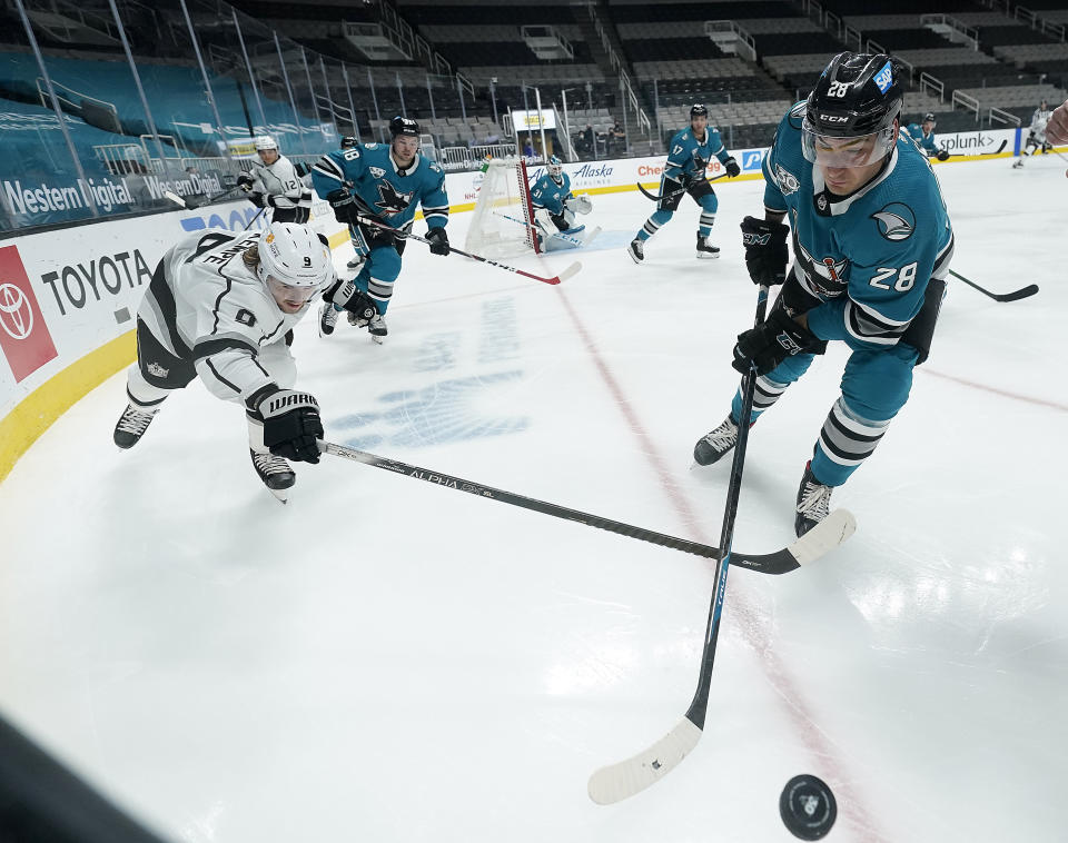 San Jose Sharks right wing Timo Meier (28) works along the boards against Los Angeles Kings right wing Adrian Kempe (9) during the second period of an NHL hockey game Saturday, April 10, 2021, in San Jose, Calif. (AP Photo/Tony Avelar)