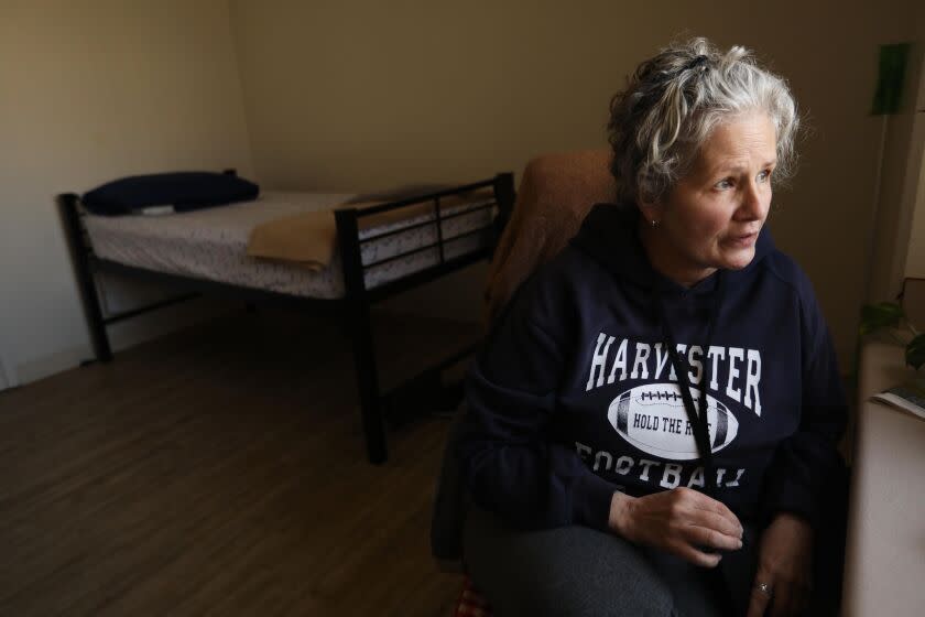 LOS ANGELES, CA - OCTOBER 12, 2022 - - Unhoused senior Linda Fett, 61, sits in her room that Supportive Services has provided for her at the Union Rescue Mission in Skid Row in Los Angeles on October 12, 2022. Fett is one of many seniors who is living without retirement savings. She is currently living on General Relief and receives food stamps to get by. She hopes to start drawing from Social Security early next year. She has been homeless periodically since 2004. On her recent bout with homelessness, Fett has been staying at the Union Rescue Mission since February of 2022.(Genaro Molina / Los Angeles Times)