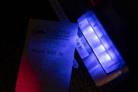 The lights of a scanner illuminate a voucher left behind on a sports betting kiosk at Turfway Park Racing & Gaming, Friday, Dec. 22, 2023, in Florence, Ky. Sports betting has spread rapidly across U.S. states in the past five years. But the odds for further expansion may be fading as state legislatures prepare to return to work in 2024. (AP Photo/Carolyn Kaster)