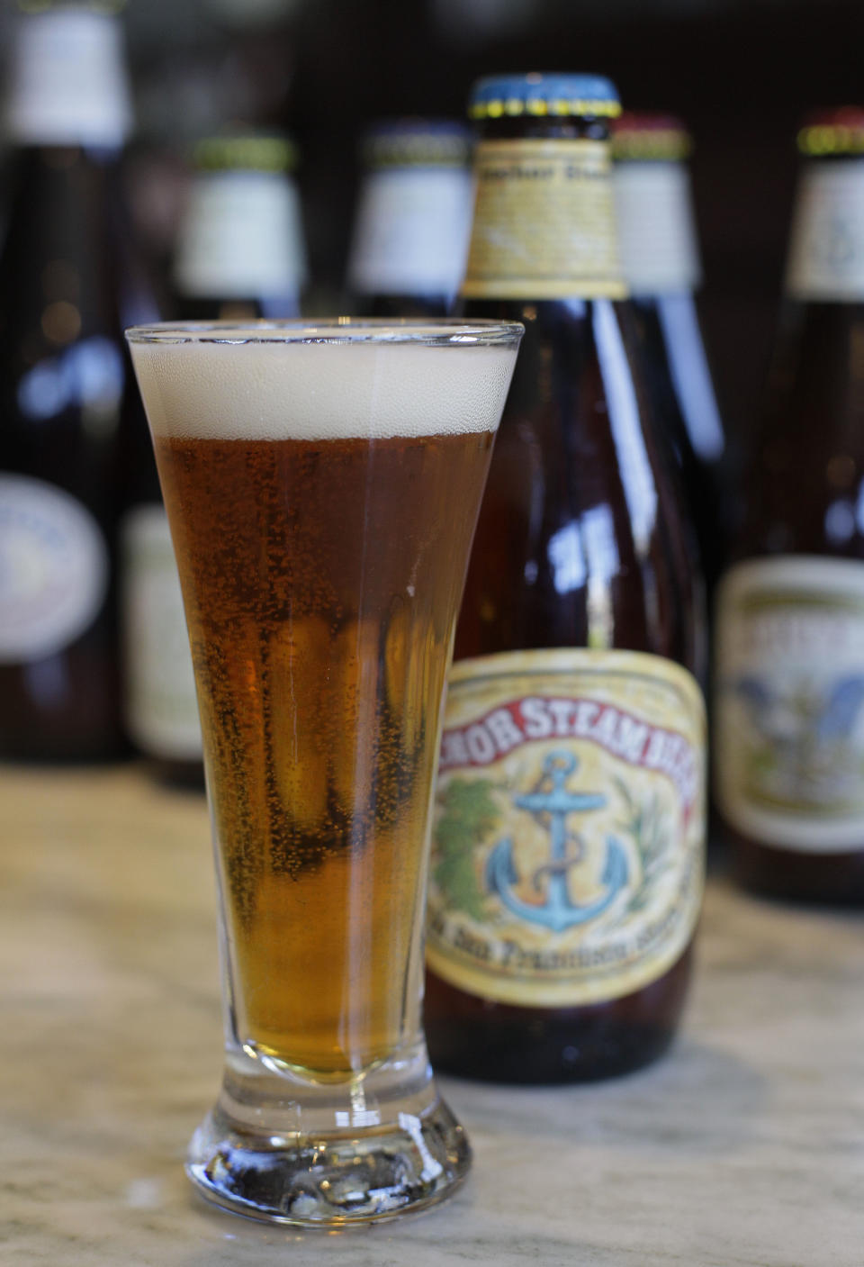 In this photo taken Wednesday, May 23, 2012, a glass and bottle of Anchor Steam beer is shown at the Anchor Brewing Co. in San Francisco. The brewery offers two free tours each day made with an advance reservation. (AP Photo/Eric Risberg)