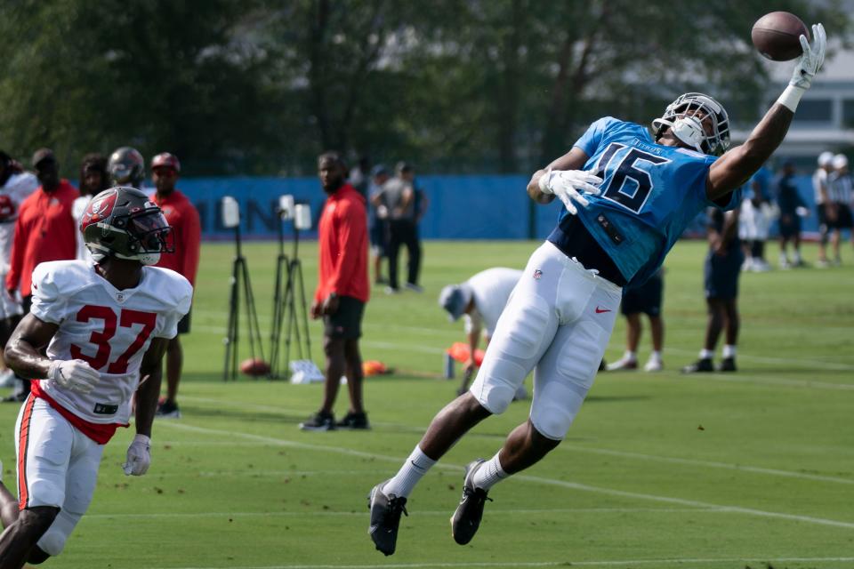 Tennessee Titans wide receiver Treylon Burks (16) makes a catch over Tampa Bay Buccaneers cornerback Kyler McMichael (37) during a joint training camp practice at Ascension Saint Thomas Sports Park Wednesday, Aug. 17, 2022, in Nashville, Tenn. 