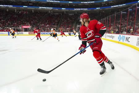 Mar 30, 2019; Raleigh, NC, USA; Carolina Hurricanes defenseman Dougie Hamilton (19) skates with the puck against the Philadelphia Flyers at PNC Arena. Mandatory Credit: James Guillory-USA TODAY Sports