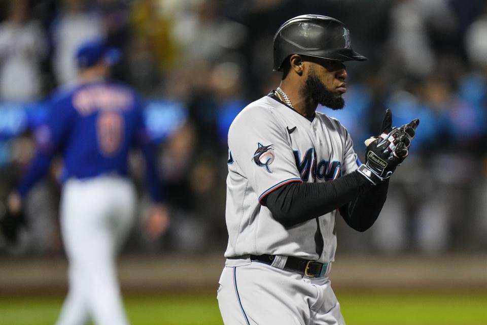 Miami Marlins' Bryan De La Cruz celebrates after hitting an RBI single as he runs to first base during the ninth inning in the second baseball game of a doubleheader against the New York Mets, Wednesday, Sept. 27, 2023, in New York. (AP Photo/Frank Franklin II)