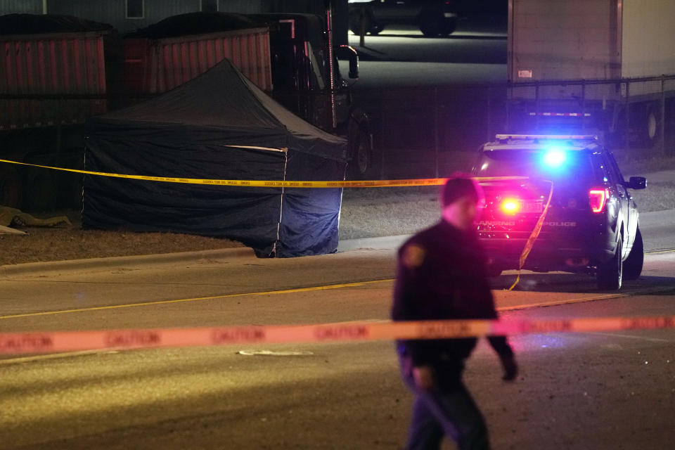 A tent covers the body of the alleged gunman, Tuesday, Feb. 14, 2023, in Lansing, Mich., who opened fire Monday night at Michigan State University, killing three people and wounding five before fatally shooting himself after a manhunt forcing students to hide in the dark. (AP Photo/Carlos Osorio)