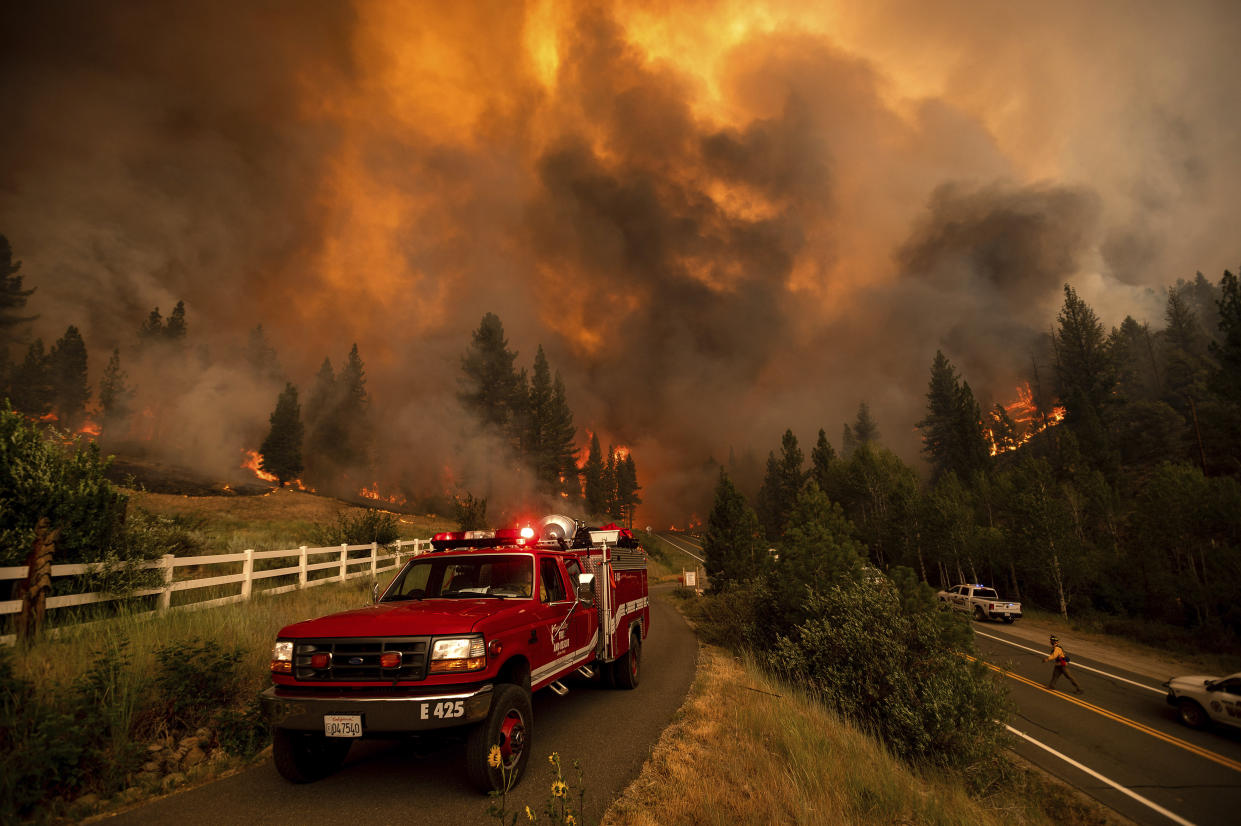 Firefighters battle the Tamarack Fire in Alpine County, Calif., on Saturday. (AP Photo/Noah Berger)