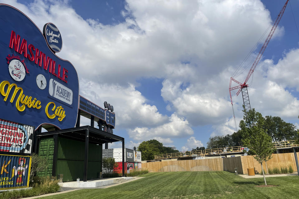 A revamped, guitar-shaped scoreboard, which was part of Greer Stadium, a former home for minor league baseball in Nashville, Tenn., stands now as a part of the Wedgewood-Houston development site Aug. 12, 2022, in Nashville. A developer says it has unearthed human remains that could be two centuries old while digging to lay the foundation of the project not far from a Civil War fort and a cemetery dating back to 1822. (AP Photo/Jonathan Mattise)