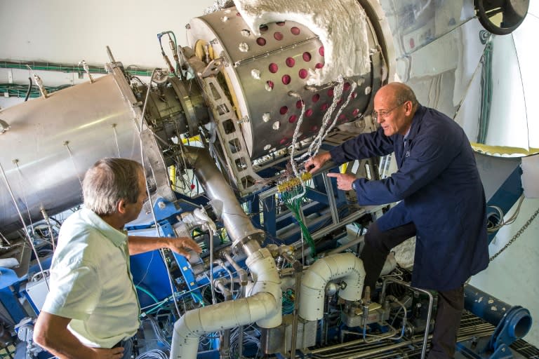 Vice president Uzi Aharony (R) and chief executive officer David Banitt of the Israeli startup company NewCO2Fuels (NCF), work on a solar test facility in Rehovot