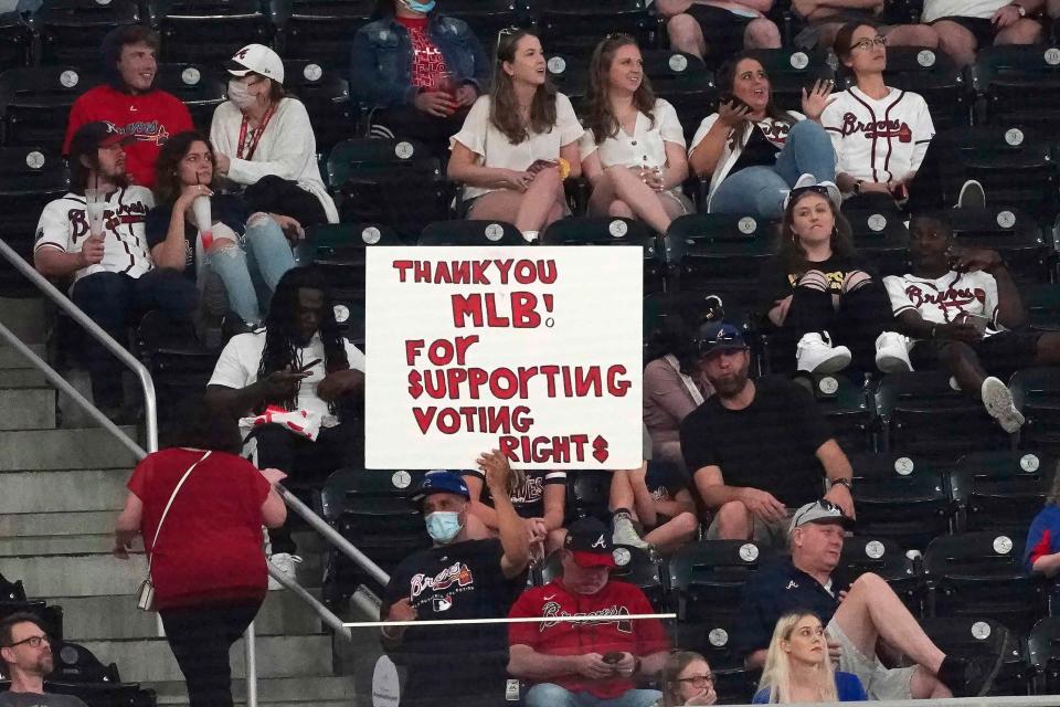 At a game on April 26, 2021, in Atlanta, a fan shows support for Major League Baseball's decision to move the All-Star Game from Georgia to Colorado.