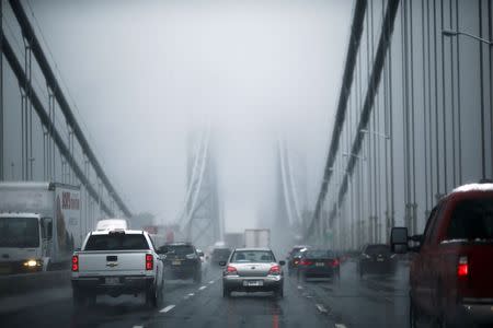 Cars make their way through the Washington bridge in New York November 26, 2014. REUTERS/Eduardo Munoz