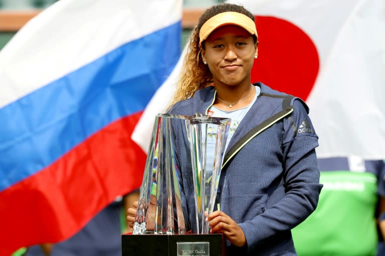 Naomi Osaka of Japan poses with the winer's trophy after defeating Daria Kasatkina of Russia during the women's final at the Indian Wells Tennis Garden