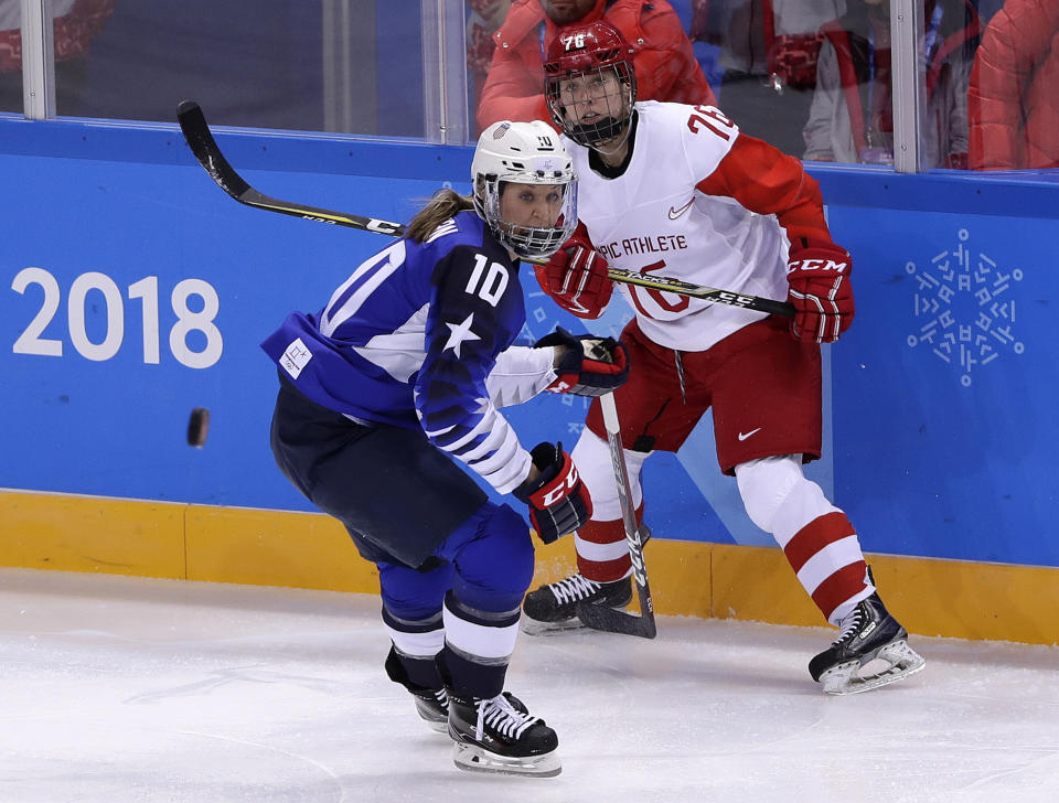 FILE - In this Feb. 13, 2018, file photo, Meghan Duggan (10), of the United States, and Yekaterina Nikolayeva (76), of Russia, chase the puck during the first period of the preliminary round of the women's hockey game at the Winter Olympics in Gangneung, South Korea. U.S. women's hockey captain Duggan announced her retirement Tuesday, Oct. 13, 2020, after a career in which she won the 2018 Olympic gold medal and seven world championship golds. (AP Photo/Frank Franklin II, File)