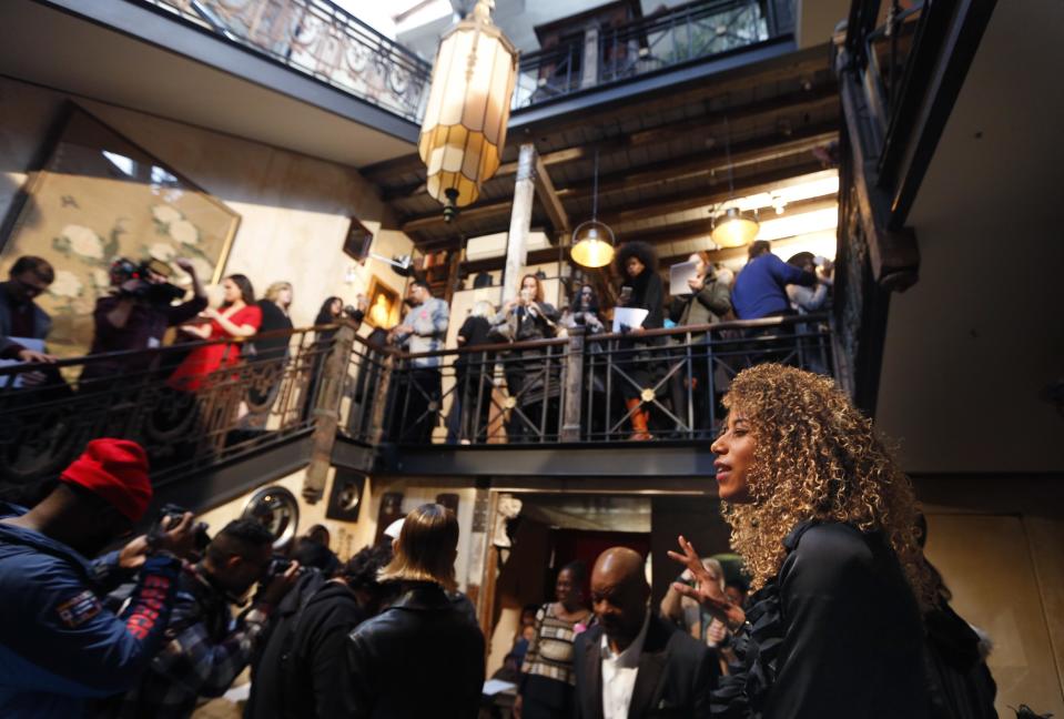 A woman reads poetry during the Tracy Reese presentation at Fashion Week in New York, Sunday, Feb. 12, 2017. (AP Photo/Seth Wenig)