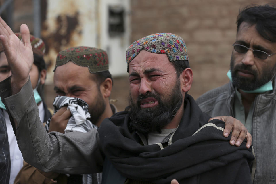 A family member of a police officer, who was killed in Monday's suicide bombing, weeps as he and others take part in a rally denouncing militant attacks and demanding peace in the country, in Peshawar, Pakistan, Friday, Feb. 3, 2023. (AP Photo/Muhammad Sajjad)