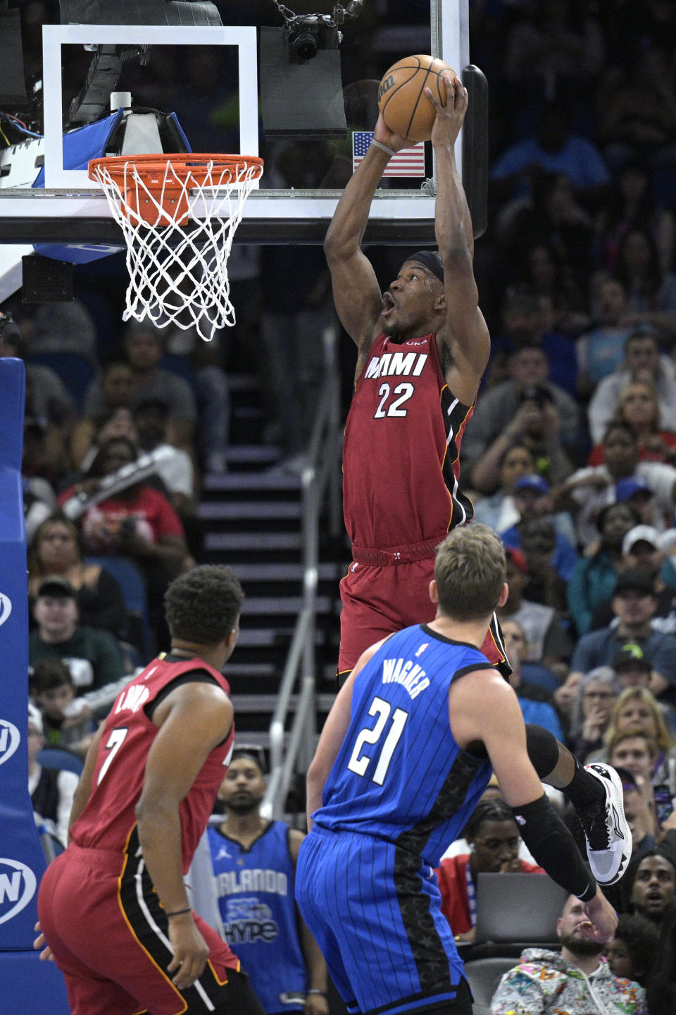 Miami Heat forward Jimmy Butler (22) dunks as Orlando Magic center Moritz Wagner (21) watches during the first half of an NBA basketball game, Saturday, March 11, 2023, in Orlando, Fla. (AP Photo/Phelan M. Ebenhack)