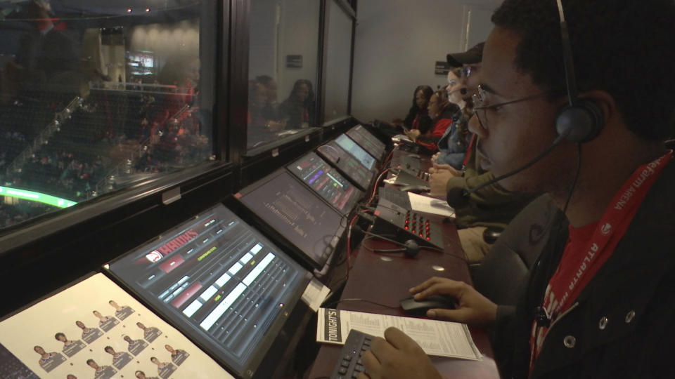 In this Thursday, Nov. 7, 2019, photo taken from video, technicians monitor video feeds from 38 cameras placed around State Farm Arena in Atlanta in order to produce 3 dimensional video replays. The Atlanta Hawks Friday will become the fifth NBA team to unveil significant financial investments into new 360-degree replay technology designed to eventually give fans the power to change the way they see the game. (AP Photo/Cody Jackson)