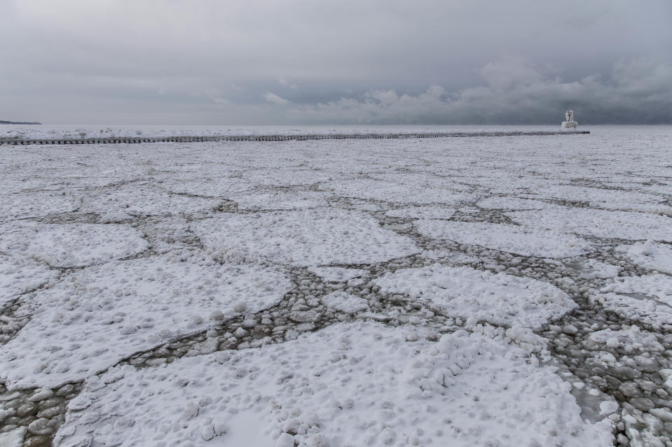 SOUTH HAVEN, MI - JANUARY 8: Ice flow between the North and South Pier, on January 8, 2015, in South Haven, Michigan.ICE engulfs a red lighthouse as a fierce winter storm grips South Haven, Michigan. Sharp icicles and surreal formations can be seen hanging from the railings after strong waves crashed onto the piers. After each coating the water quickly freezes to ice and the pier is transformed into a slippery, white wonderland. Weather in the area dipped into the minus figures and froze over Lake Michigan in the beginning of January.PHOTOGRAPH BY Mike Kline / Barcroft MediaUK Office, London.T +44 845 370 2233W www.barcroftmedia.comUSA Office, New York City.T +1 212 796 2458W www.barcroftusa.comIndian Office, Delhi.T +91 11 4053 2429W www.barcroftindia.com