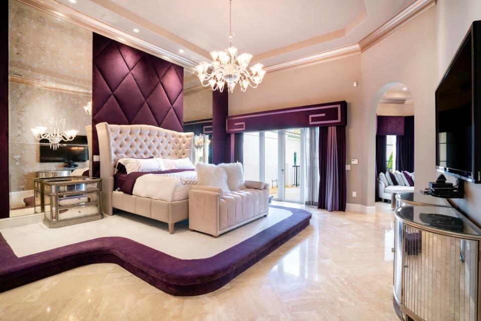 The dramatic primary bedroom has a sitting area and a veranda. Become Legendary / ONE Sotheby's International Realty