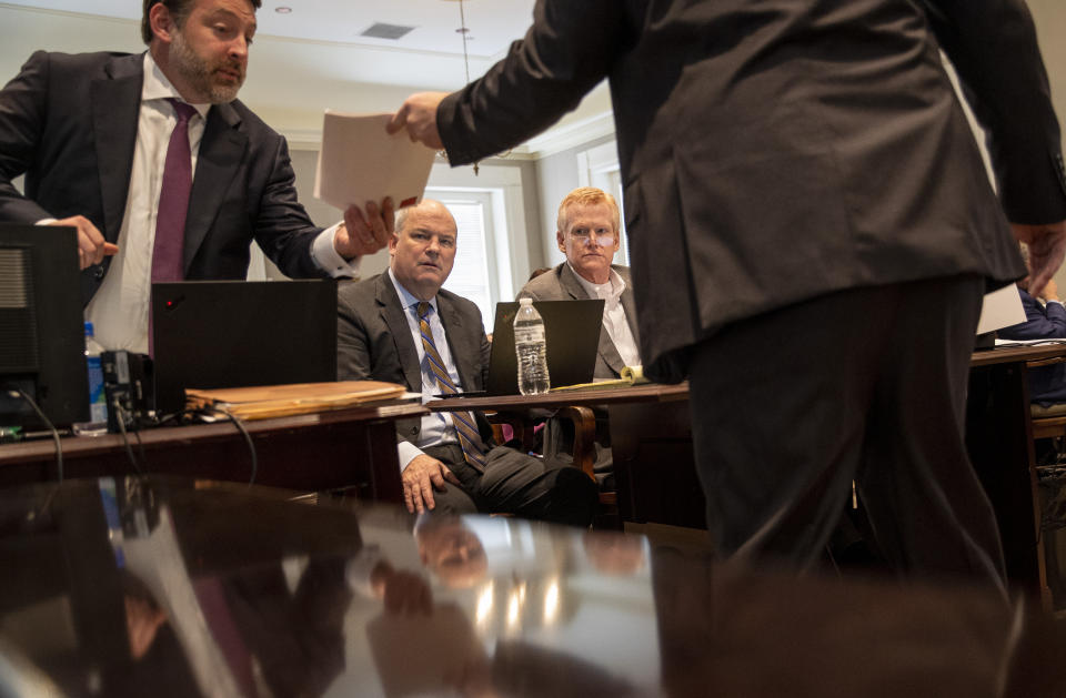 Defense attorney Phillip Barber is shown the state's exhibit evidence by prosecutor John Conrad in the double murder trial of Alex Murdaugh at the Colleton County Courthouse in Walterboro, S.C., Wednesday, Feb. 1, 2023. (Andrew J. Whitaker/The Post And Courier via AP, Pool)