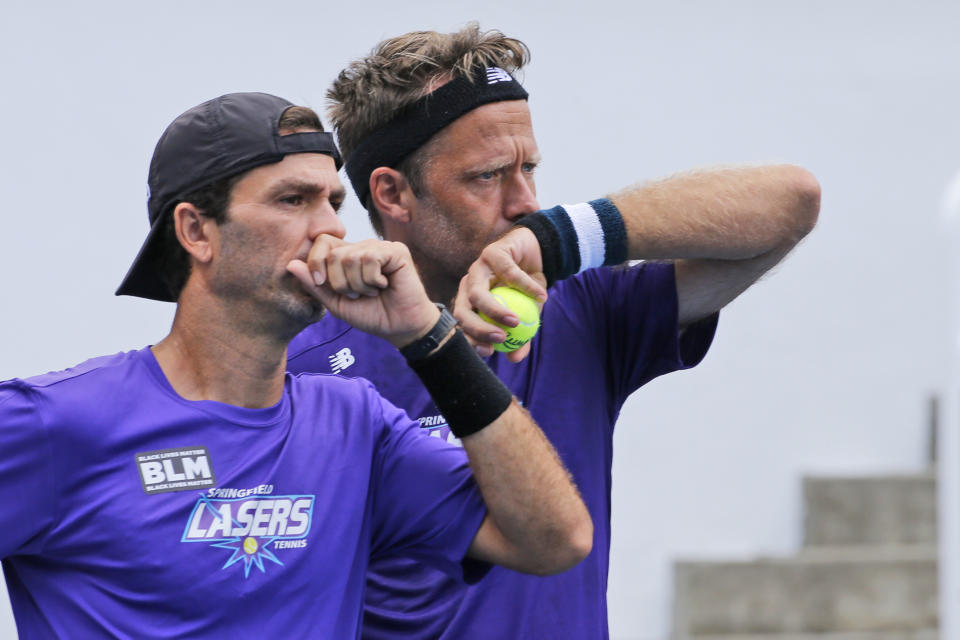 Springfield Laser tennis players, Robert Lindstedt, right, and teammate, Jean-Julien Rojer, left, share strategy during the World TeamTennis tournament at The Greenbrier resort Sunday, July 12, 2020, in White Sulphur Springs, W.Va. (AP Photo/Steve Helber)