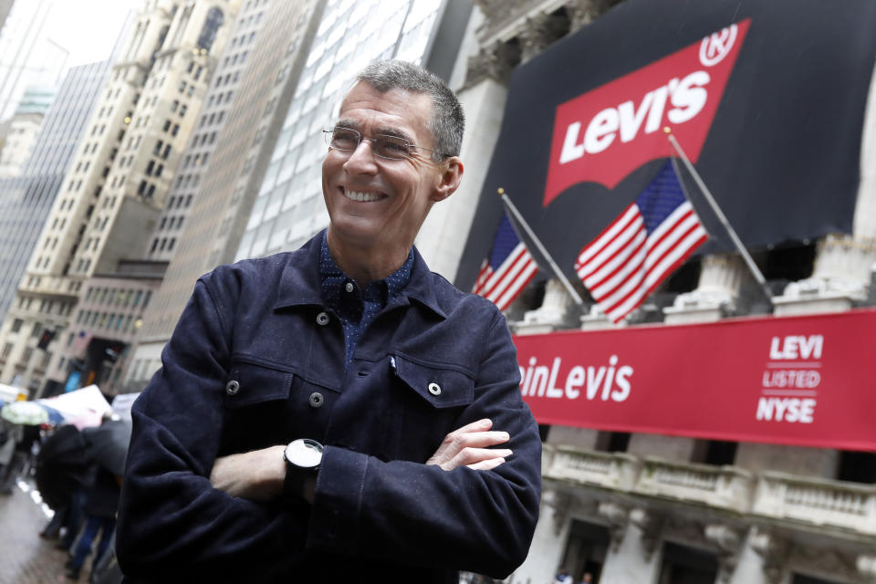 Levi Strauss CEO Chip Bergh poses for photos outside the New York Stock Exchange, Thursday, March 21, 2019. Levi Strauss & Co., which gave America its first pair of blue jeans, is going public for the second time. The 166-year-old company, which owns the Dockers and Denizen brands, previously went public in 1971, but the namesake founder's descendants took it private again in 1985.(AP Photo/Richard Drew)